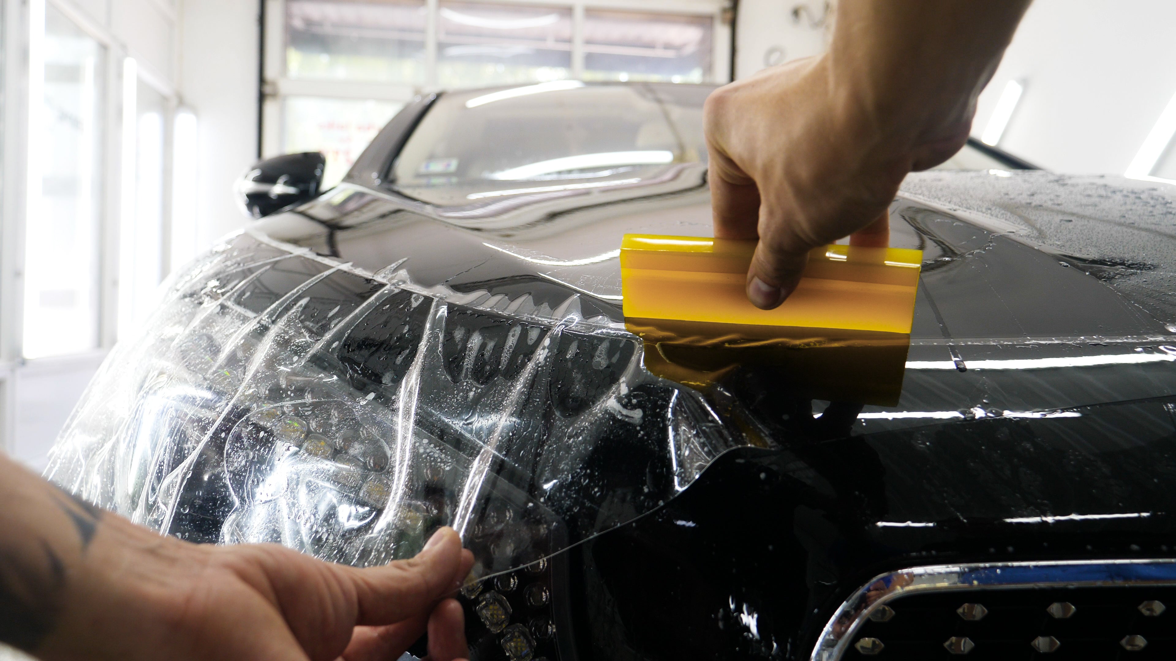 stylish black sports car having paint protection film applied